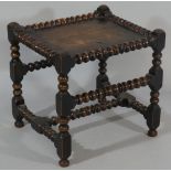 A rectangular stool with panelled top, bobbin turned mouldings,