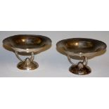 A pair of hammer textured pedestal bowls in Arts & Crafts style the circular dished tops on three