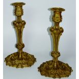 A pair of Louis XV style ormolu candlesticks with shell and leaf cast waisted knopped stems on
