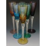 A harlequin set of six wine glasses on air-twist stems, bowls and feet in varying colours,