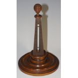 An olive wood pyramid shaped thermometer topped by turned wood reeded sphere-shaped finial,