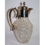 An Edward VII cut glass claret jug with silver collar, hinged lid and handle,