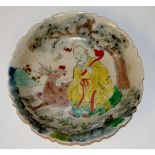 A Chinese shaped circular dish polychrome decorated with a figure and stag beneath a tree,