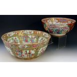 A Cantonese Famille Rose circular bowl decorated in typical palette with reserves of figures in