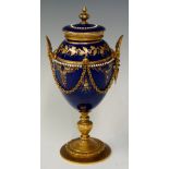 A French ormolu mounted porcelain urn and cover the Bleu De Roi body decorated with jewelling,