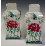 A pair of Chinese porcelain flattened baluster vases decorated to three sides with large pink