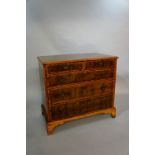 An oyster veneered walnut chest in William and Mary style, the boxwood strung top with circles,