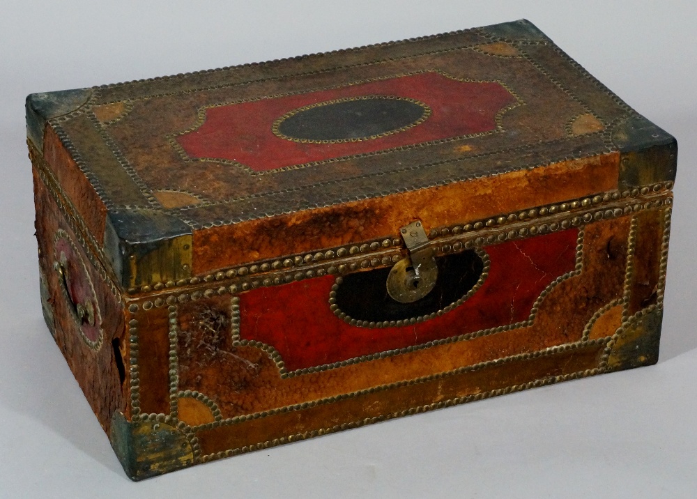 An early 19th Century leather covered cedar box decorated overall with studded bands of shaped