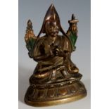 A bronze Buddha with fruiting leafy sections to the shoulders,