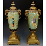 A pair of brass mounted porcelain urns each decorated in Chinoiserie style on a turquoise ground