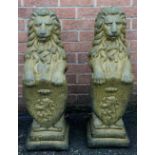 A pair of reconstituted lions, 84cm high,
