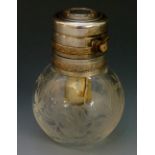 An early 20th Century engraved spherical glass perfume bottle with white metal top depressing to