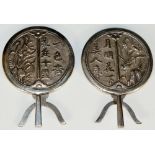 A pair of Chinese menu holders, the circular fronts cast with leafage and script,