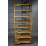 A Victorian eight tier stand with pine shelves and turned oak supports and finials, 210cm high,