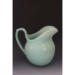 Susie Cooper - a turquoise glazed large jug, 21cm high,