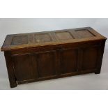 An oak four panel blanket chest with hinged lid and plain front, 143cm wide,
