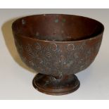 A copper oxidised white metal pedestal bowl cast with continuous band of peacocks, 15cm diameter,