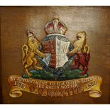 Two reproduction armorial crests - one reads "By Appointment To HM Queen Elizabeth, G.