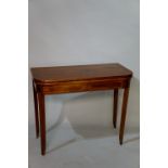 A George IV mahogany tea table outlined with boxwood stringing the rounded rectangular top above a