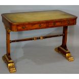 A Regency parcel gilt mahogany two drawer writing table outlined with ebonised stringing the