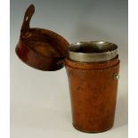 A set of four tapered cylindrical beakers contained within a leather case, 15cm high,