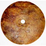 A Chinese Jade Bi disc of circular design relief carved with scrolls and symbols,