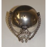 An unusual Scottish silver string holder of spherical design with suspension chain and pierced