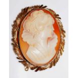 An oval shell cameo carved with the head and shoulders of a young woman,