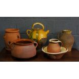 A terracotta Pansion, 32cm diameter; three terracotta jugs,