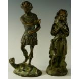 A bronze figure of a man standing upon stylised dragon,