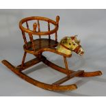 A late 19th Century child's rocking chair with circular two handled upper ring above bobbin gallery,