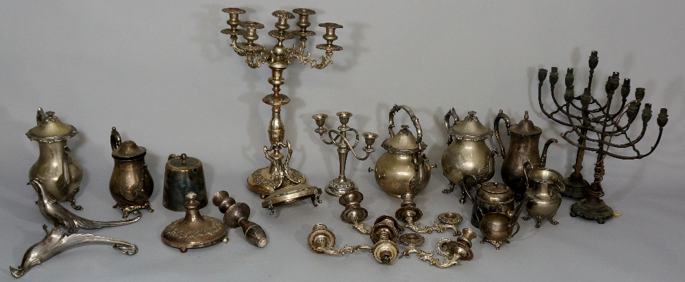 A quantity of silver plated teapots, jugs, candlesticks, etc.