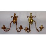 A pair of brass two branch wall lights in the style of WAS Benson with oval back plates,