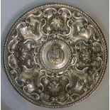 A fine Continental silver commemorative dish the broad rim embossed with shells, scrolls,
