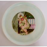 A Derby circular cabinet plate painted to the centre with a female figure seated on an upholstered