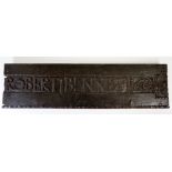 A 17th Century oak panel fragment carved -  'Robert Bennett 1666' within carved border, 71cm wide,