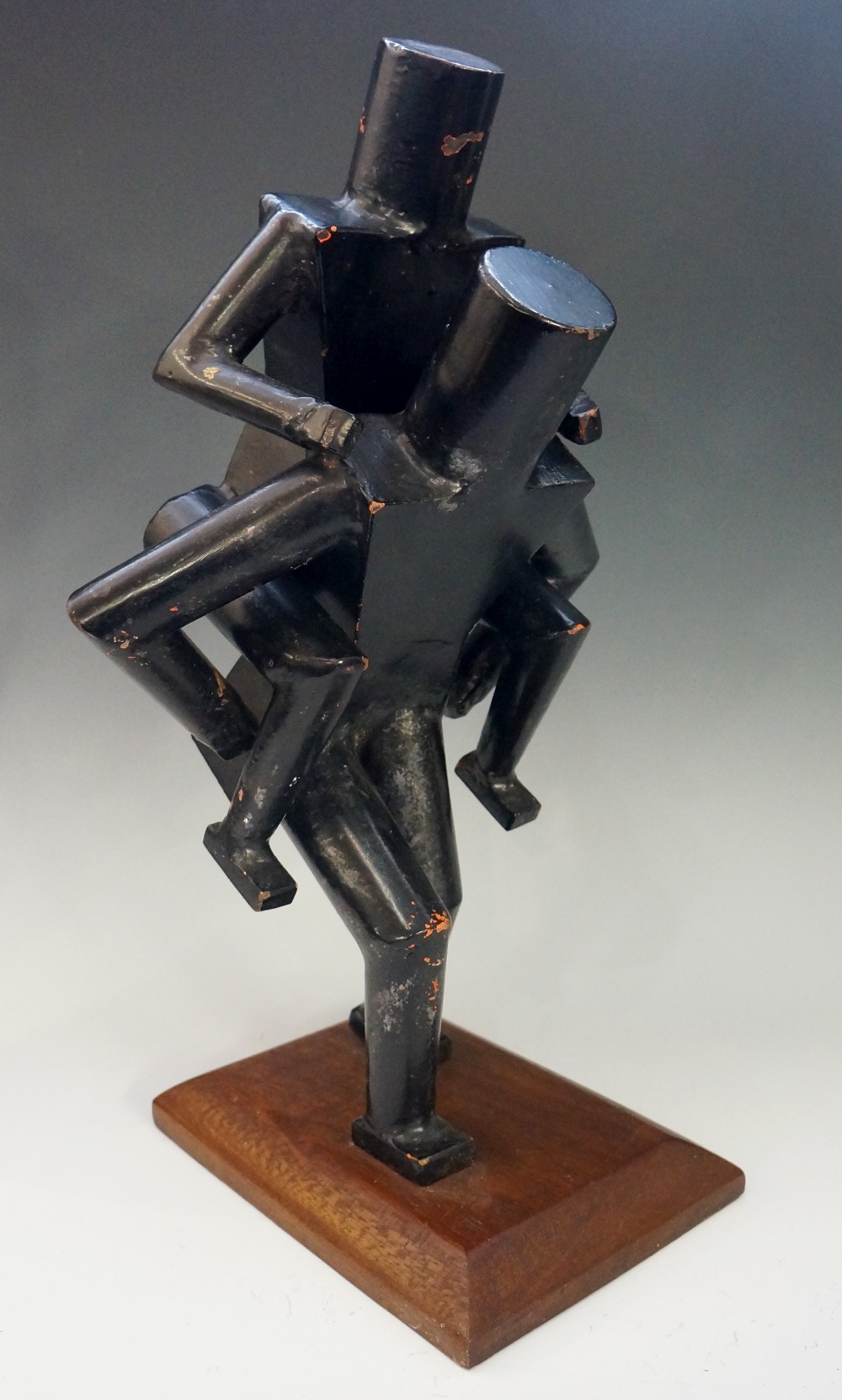 A Modernist sculpture of a figure carrying another figure on its back,