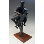 A Modernist sculpture of a figure carrying another figure on its back,