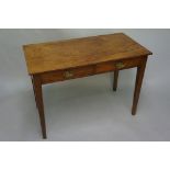 A George III mahogany two drawer side table on square tapered legs, oval brass escutcheons,