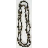 A black glass necklace moulded with stylised beetles and beads, detailed in gilt,