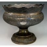 A large Indian silver? pedestal bowl repoussé decorated overall with bands of trailing leafage with