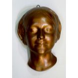 A 19th Century plaster death mask of the 'Unknown Lady of the Seine', bronzed painted finish,