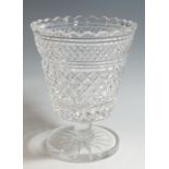 A cut glass pedestal vase with scalloped edge and diamond design to body,