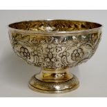 A silver rose bowl embossed with scrolling foliage, by C. S. Harris & Sons Ltd, London 1910, 14.