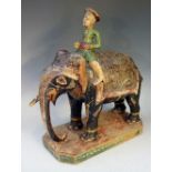 A 19th Century Indian carved model of an elephant with mahout, polychrome decorated,
