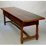 A large French cherry wood serving table the rectangular top above a deep frieze fitted pair of