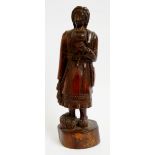 An 18th Century solid yew wood carving of a peasant woman with child on her back,