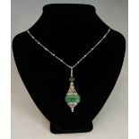 An Art Deco emerald and diamond pendant on a seed pearl set chain,