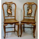 A pair of Chinese hardwood chairs the hoop backs with splats carved with leafage and inlaid with