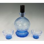 An Art Deco blue glass decanter with cut and engraved leaf and line design to body,